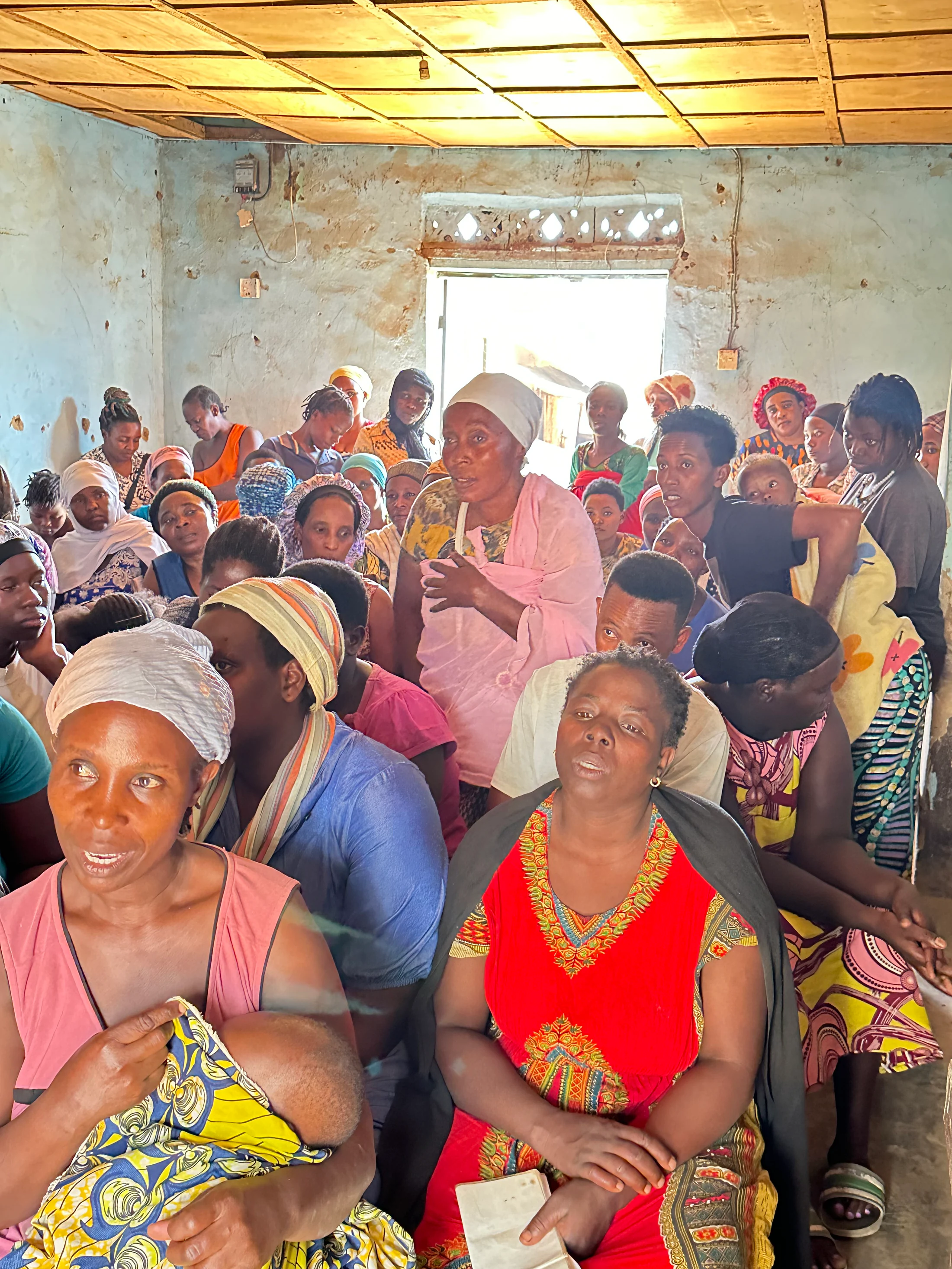 Women gathered in a community conversation in Nakivale