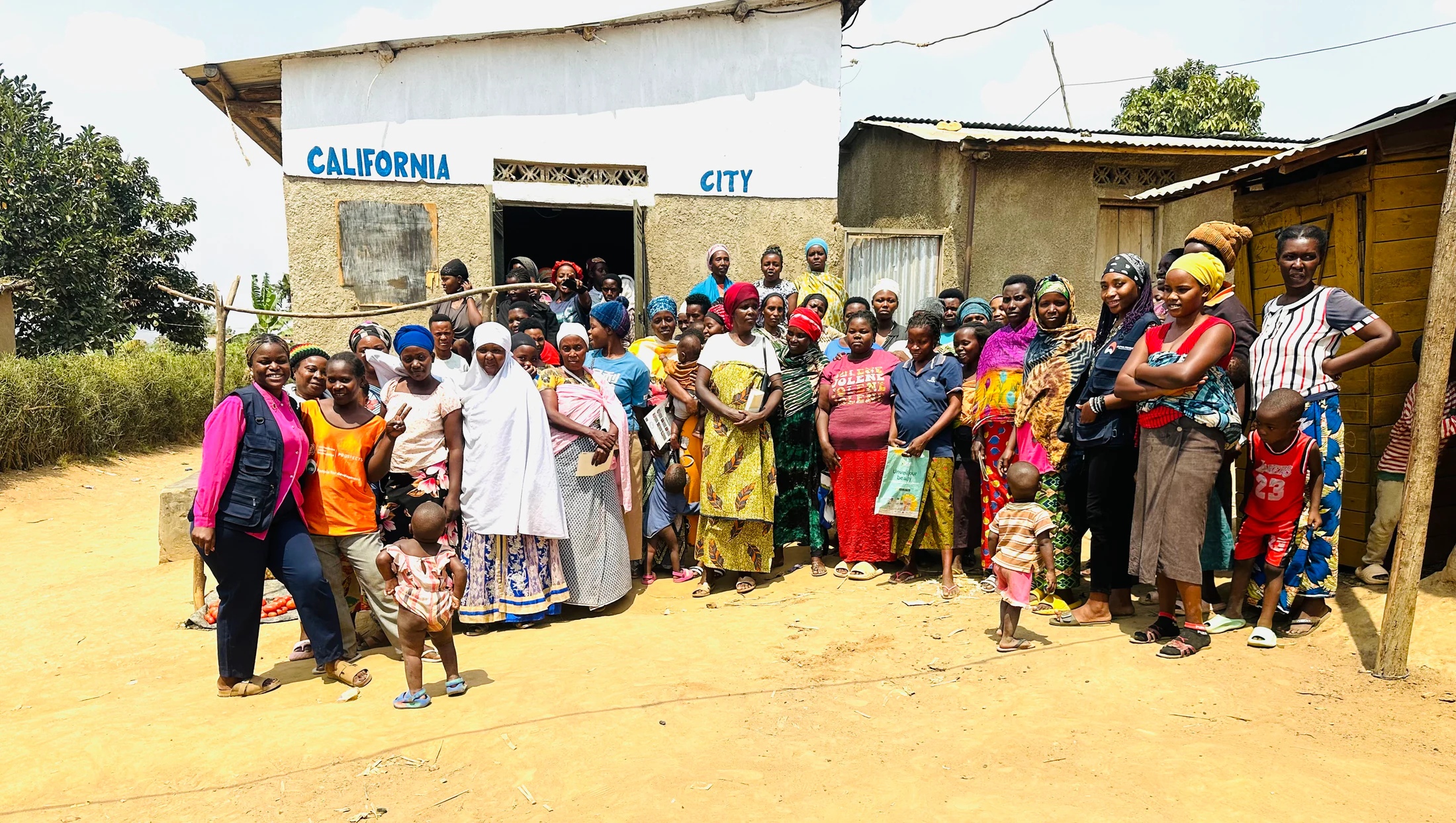 Women and children gathered outside a community building in Nakivale